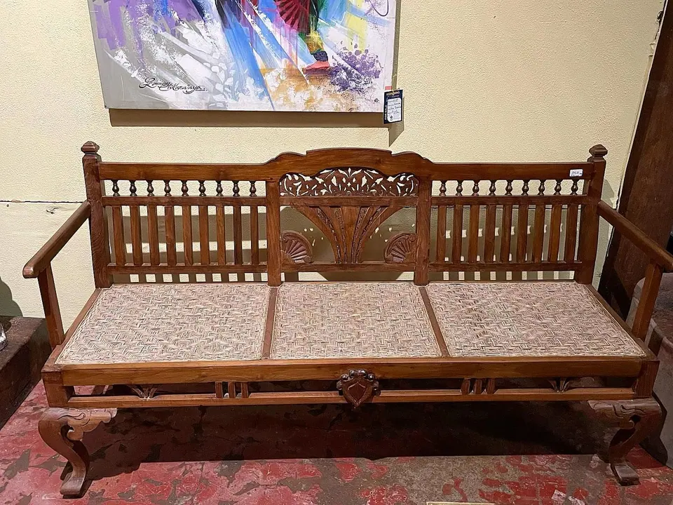 A carved wooden bench sofa
