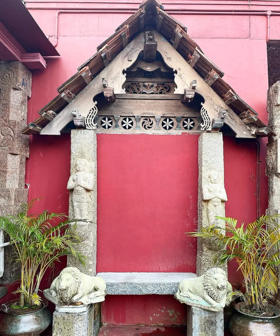 Carved Wooden Doorway with Stone Guardians